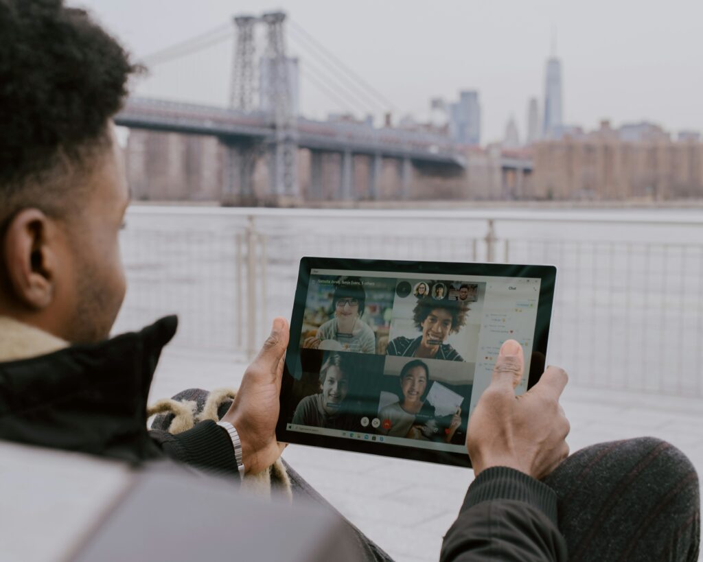 “Remote teams collaborating using communication tools like Slack, Zoom, and Microsoft Teams”