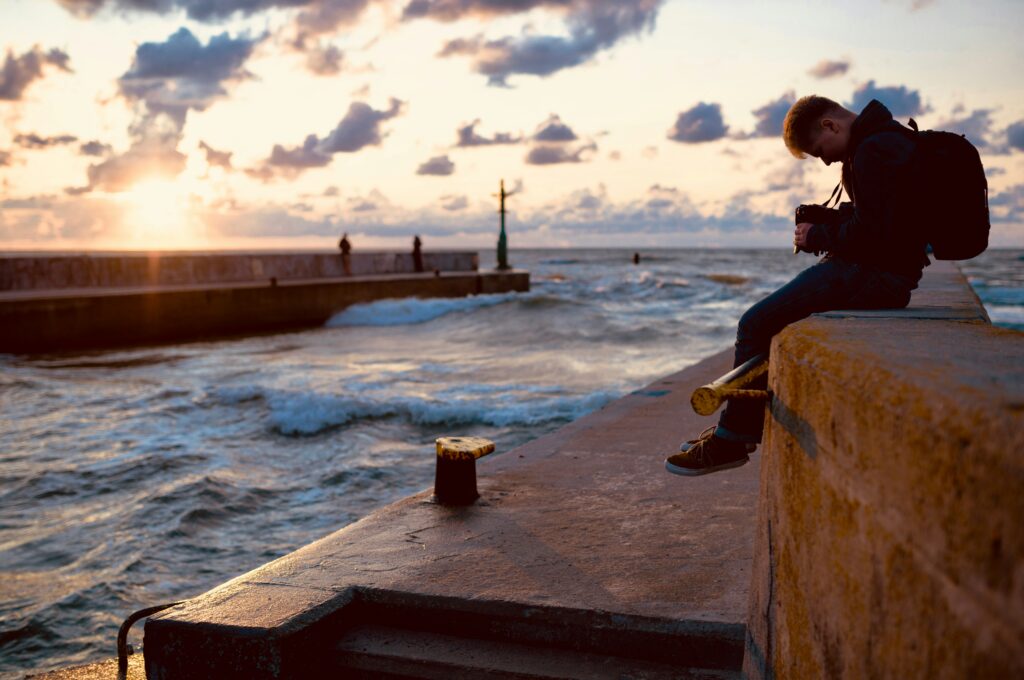 Remote work lifestyle – digital nomad working from a beach café in 2025.